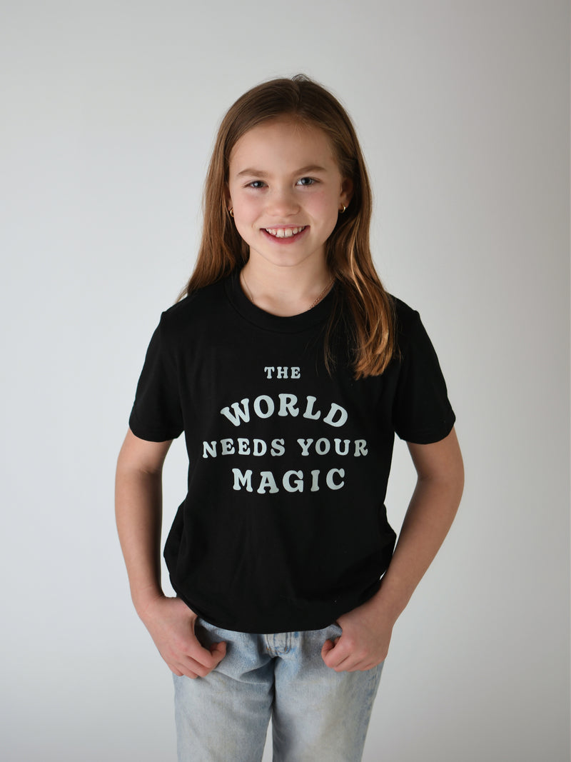 THE WORLD NEEDS YOUR MAGIC – IN KIDS BLACK Storied & TEE Folk